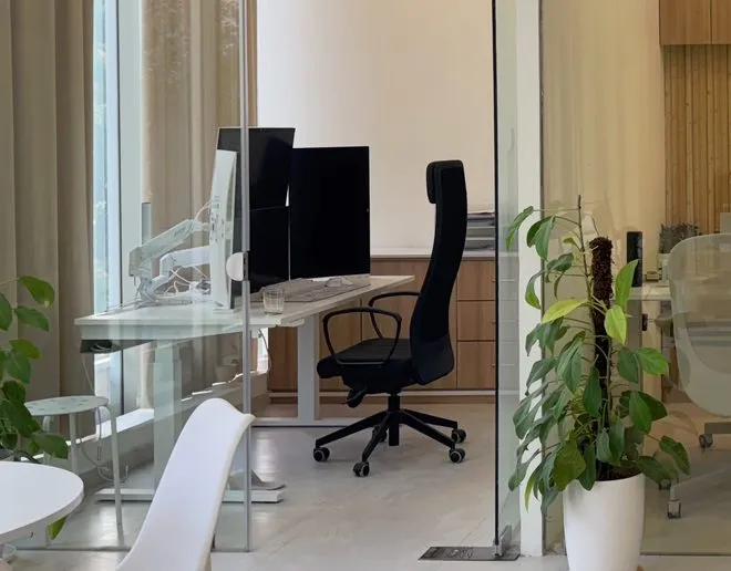 Private cabin with height-adjustable desk, dual monitors and ergonomic chair