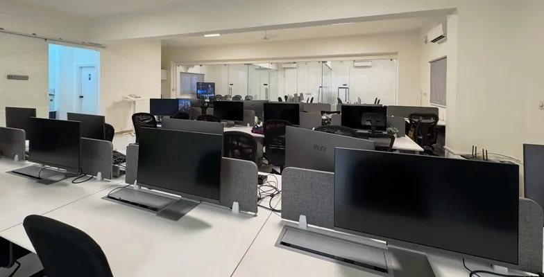 Rows of monitors and IT equipment on the KV Consulting office floor in Bangalore